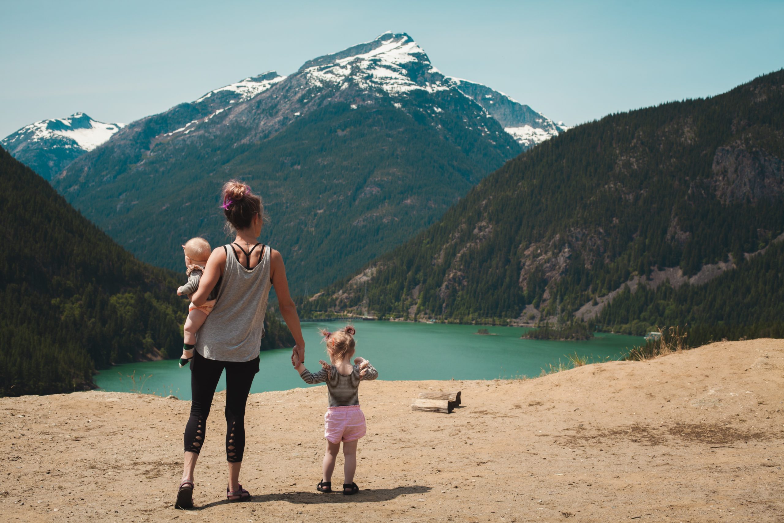 woman with a baby and toddler in front of mountains